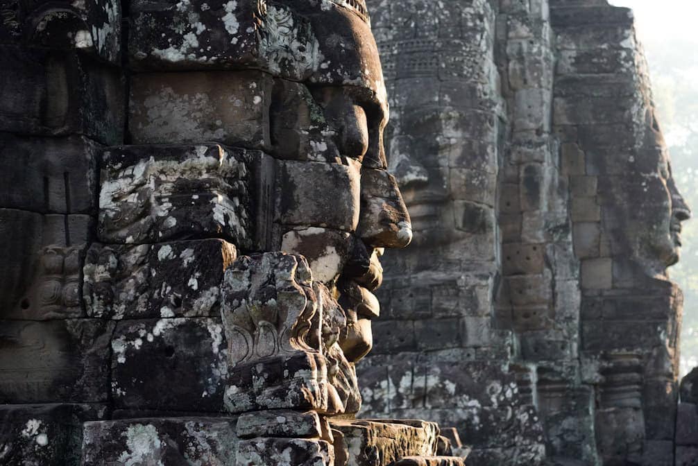 Close-up of stone carvings and faces at Angkor Wat temple in Cambodia.